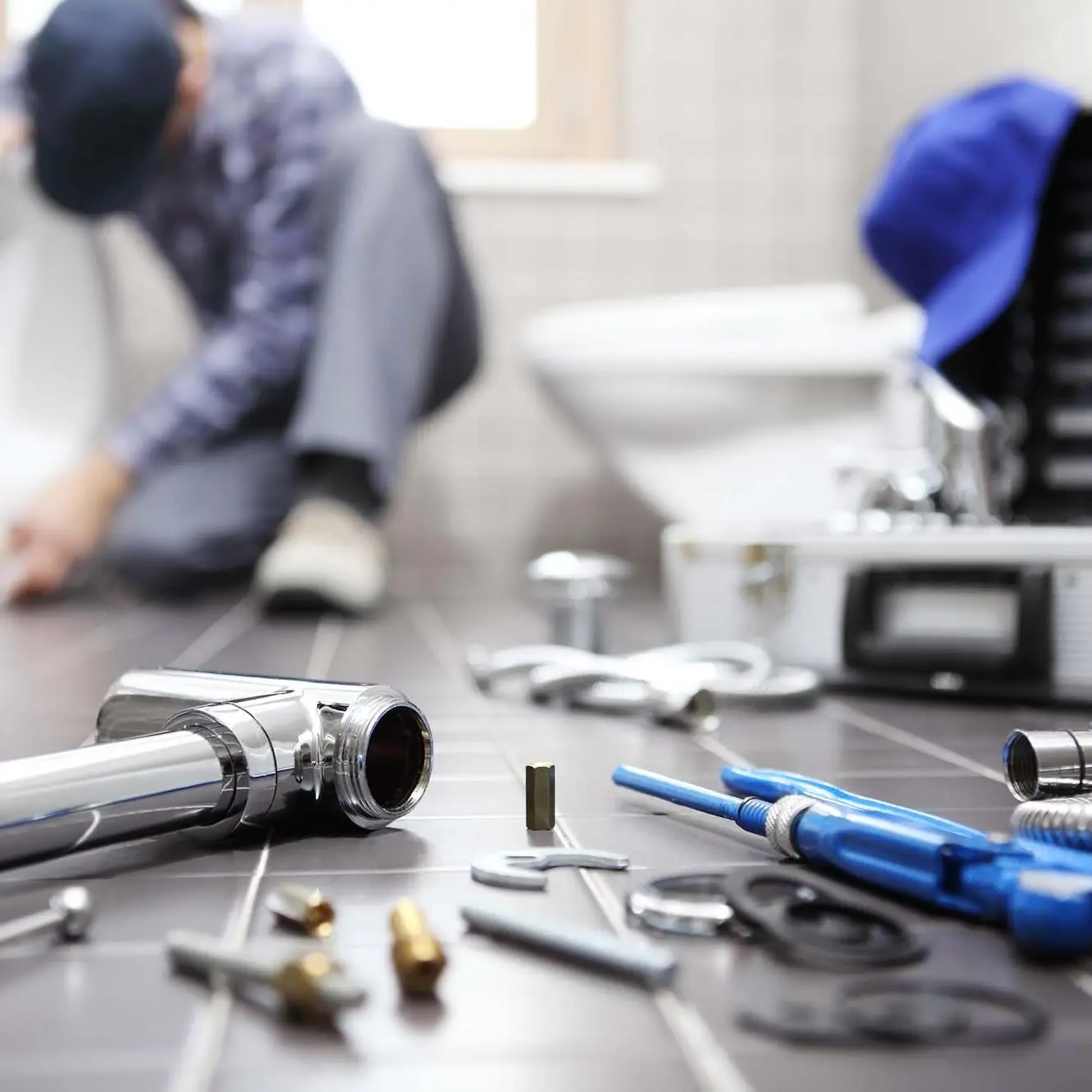 Plumber at work in a bathroom, plumbing repair service, assemble and install concept